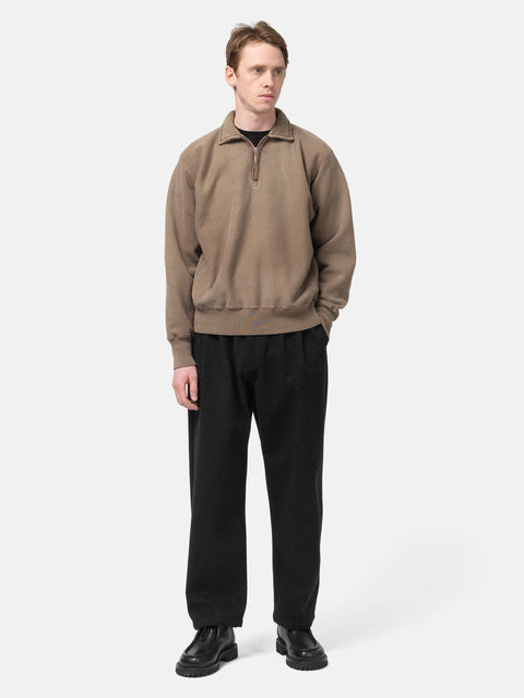 Model standing in studio wearing the A.PRESSE Vintage Half Zip Sweatshirt in Brown