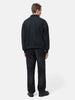 rear view of the model standing in studio wearing the A.PRESSE Vintage Sweat Cardigan in Black