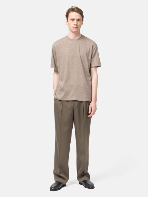 Model standing wearing the AURALEE Seamless Crewneck Tee in Top Brown