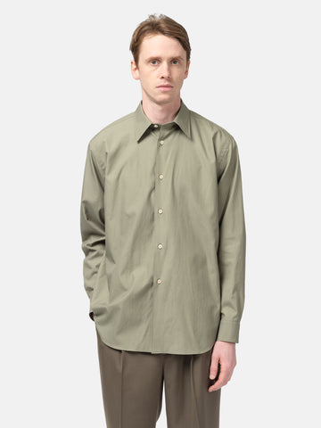 Half body shot of the Model standing in studio wearing the AURALEE Washed Finx Twill Shirt in Olive