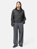 full-body view of the model wearing LEMAIRE Pleated Tailored Pants Carbon