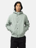 Half body shot of the model wearing the Stone Island Light Soft Shell-R_E.Dye® Technology Hooded Jacket Sage