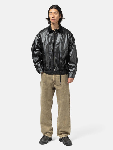 Model standing in studio wearing the cotton denim 5 pocket wide pants in brown from URU