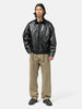 Model standing in studio wearing the cotton denim 5 pocket wide pants in brown from URU
