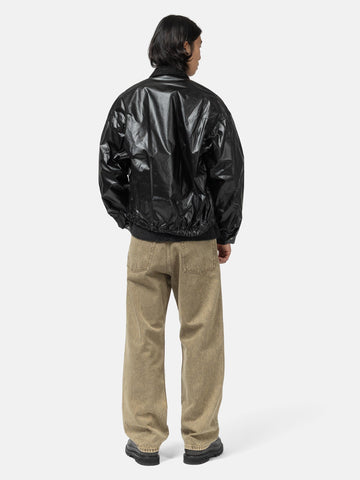 Rear shot of the Model standing in studio wearing the cotton denim 5 pocket wide pants in brown from URU