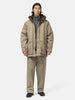 Model standing in studio wearing the organic cotton chino half coat from URU.