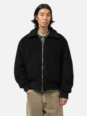 Close up shot of the model in studio wearing the wool boa zip-up blouson from URU.