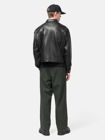 Rear view of the model standing in the studio wearing the  ULIKELY Skater's Work Pants in Green