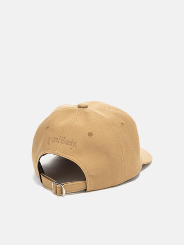 Rear Shot in studio of the UNLIKELY Team Cap in Beige with adjustable back strap
