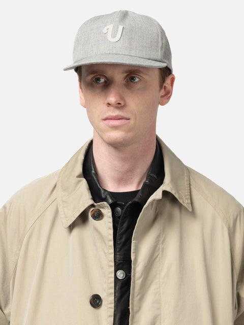 Shot in studio of the UNLIKELY Team Cap in Gray worn by model
