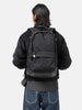 Model wearing the Visvim Cordura 22L backpack in black on the shoulder.