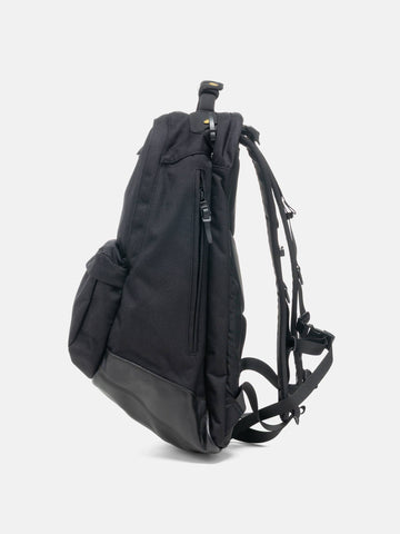 Side view of the Visvim Cordura 22L backpack in black