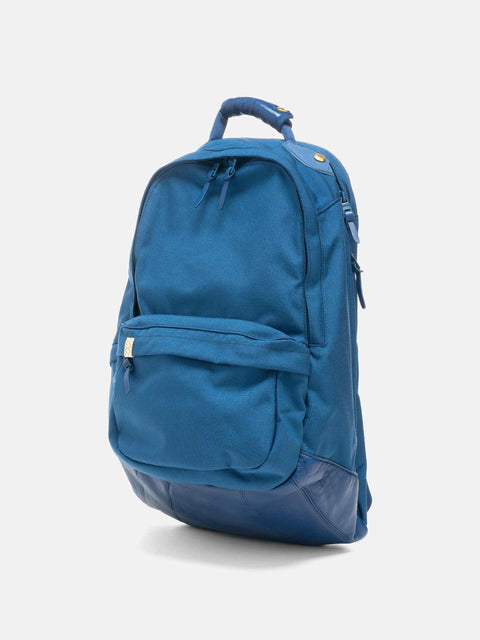 Studio shot of the Visvim-Cordura-22L Blue backpack in charcoal.