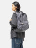 Model wearing the Visvim Cordura 22L backpack in Charcoal on the shoulder.