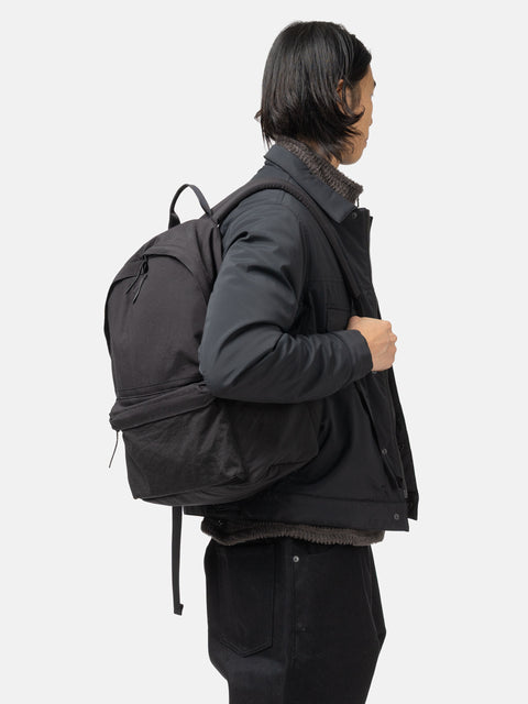 Model is wearing the HOBO Backpack 22L Nylon Oxford Onibegie Dyed Charcoal